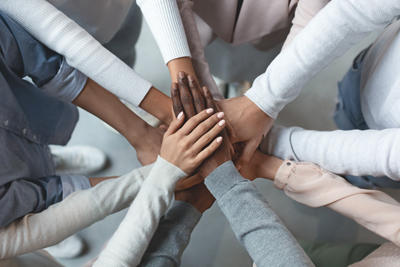 Group of multi ethnic hands clasping